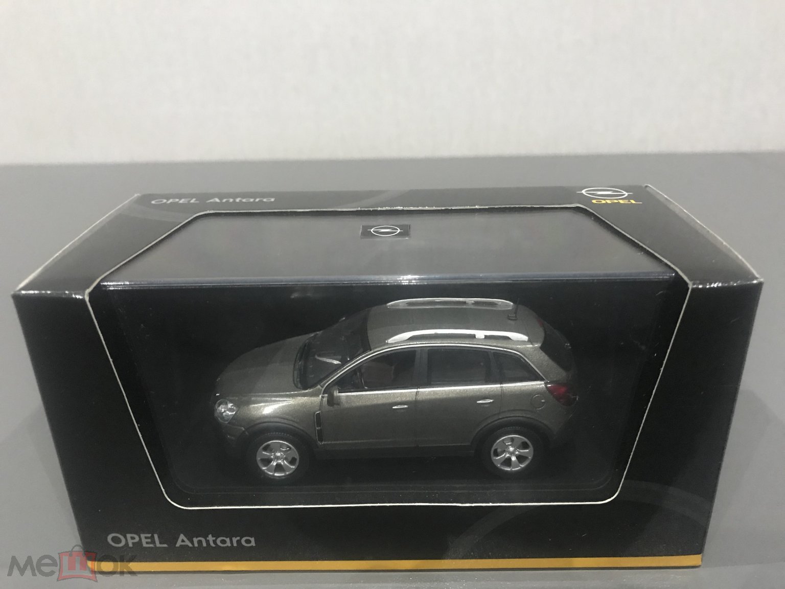 Положить в корзину Norev модель авто Opel Antara серо-золотистый масштаб  1:43